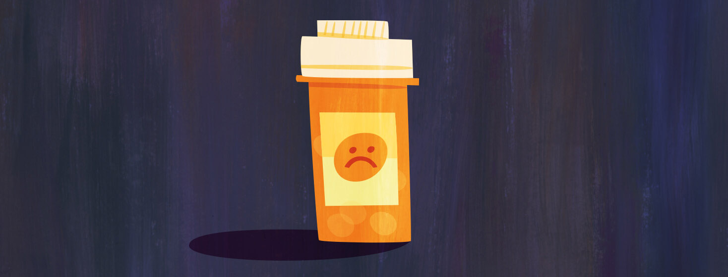 A pill bottle with a sad face on it denoting negative side effects of medication