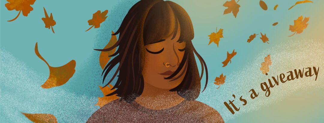 A person closes their eyes enjoying breathing in the fall breeze while leaves blow by.